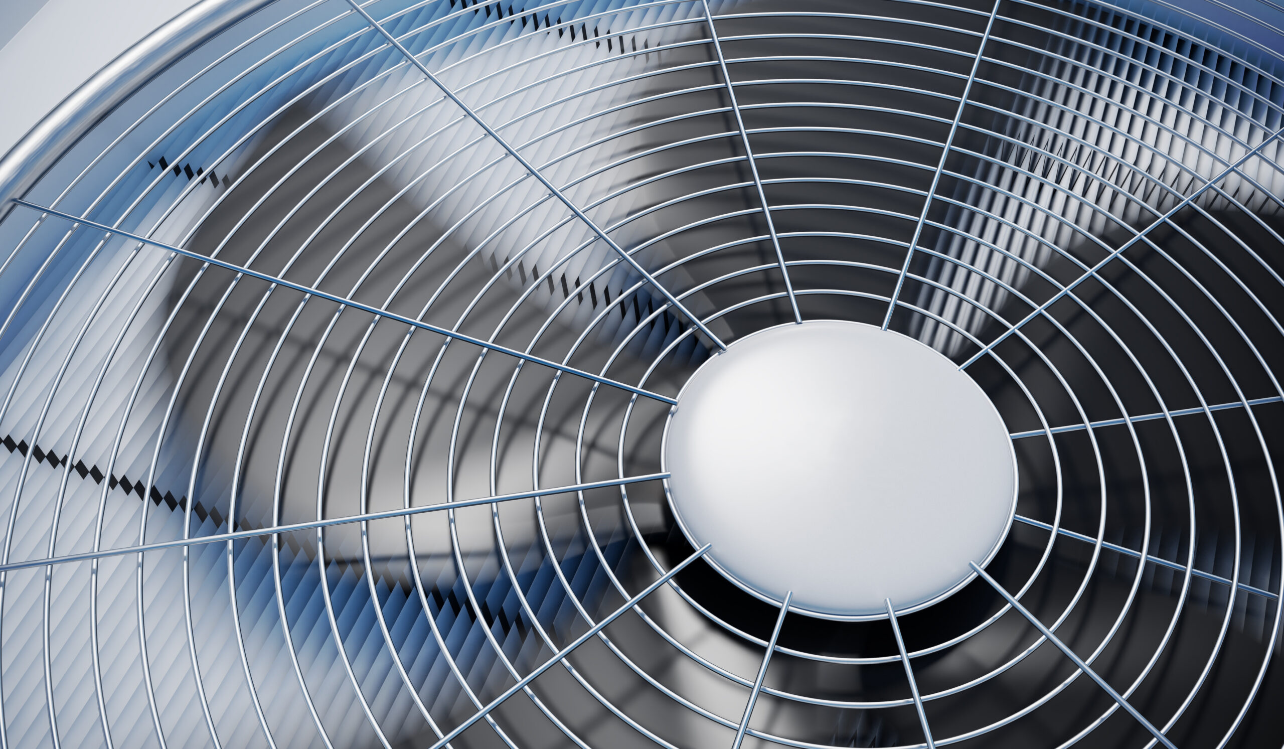 Close-up view of a fan spinning on an HVAC unit.